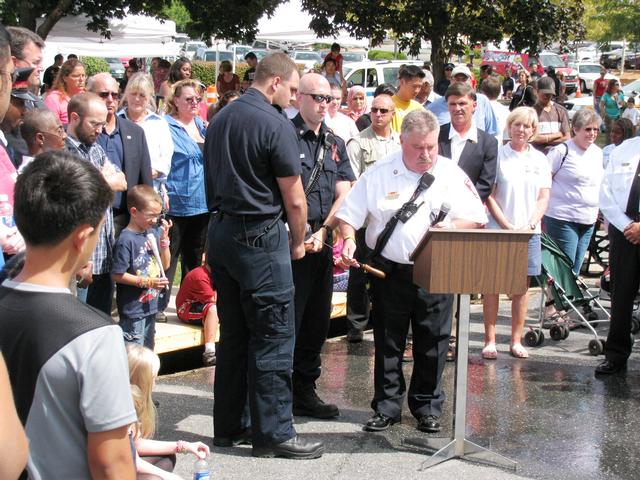 Chief Chornock with the help of Firefighters Robert McHenry III and Rob King tolls the bell four sets of five in remembrance of the last call of a firefighter in memory of the 343 firefighters lost on 9/11. 